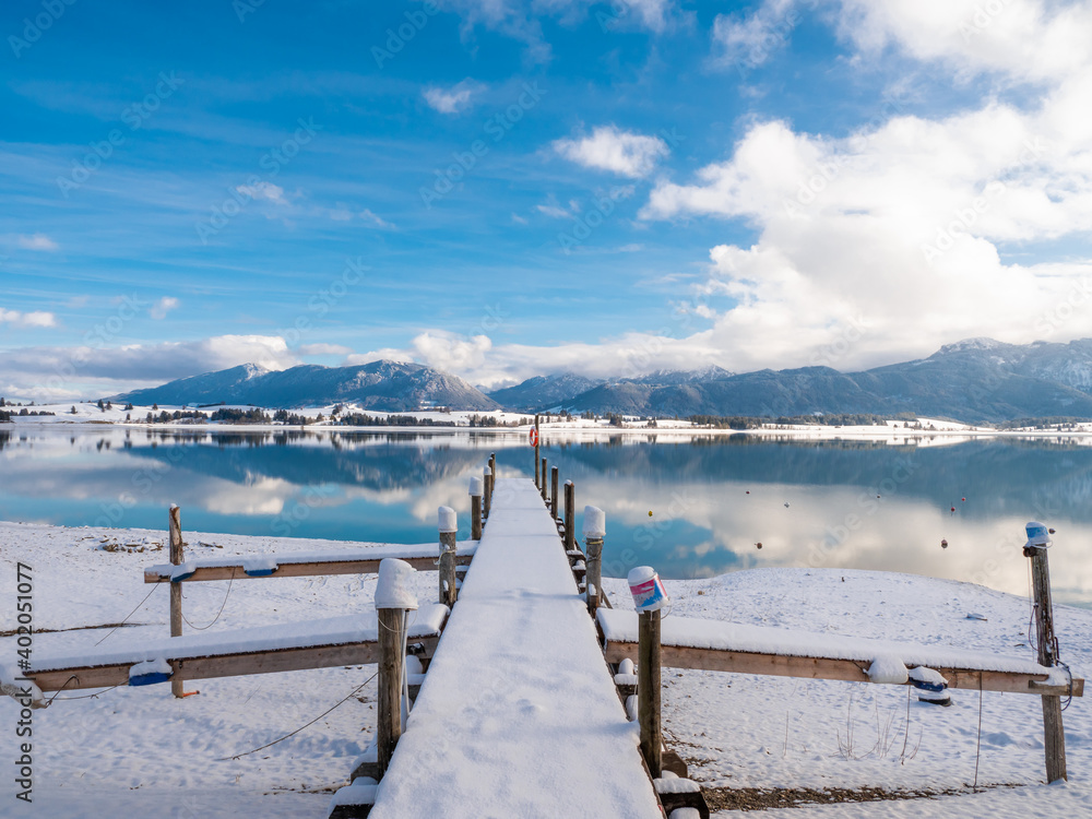 Forggensee in winter and mountains