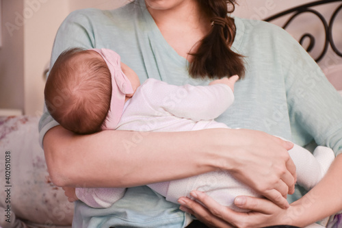 Little girl newborn baby sleeping in her mother's arms © Ersin