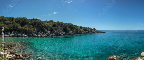 Rocky coastline beach in Croatian island Pag with blue sea.
