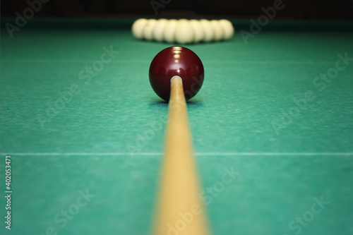 Closeup shot of red ball going in billiard pocket photo