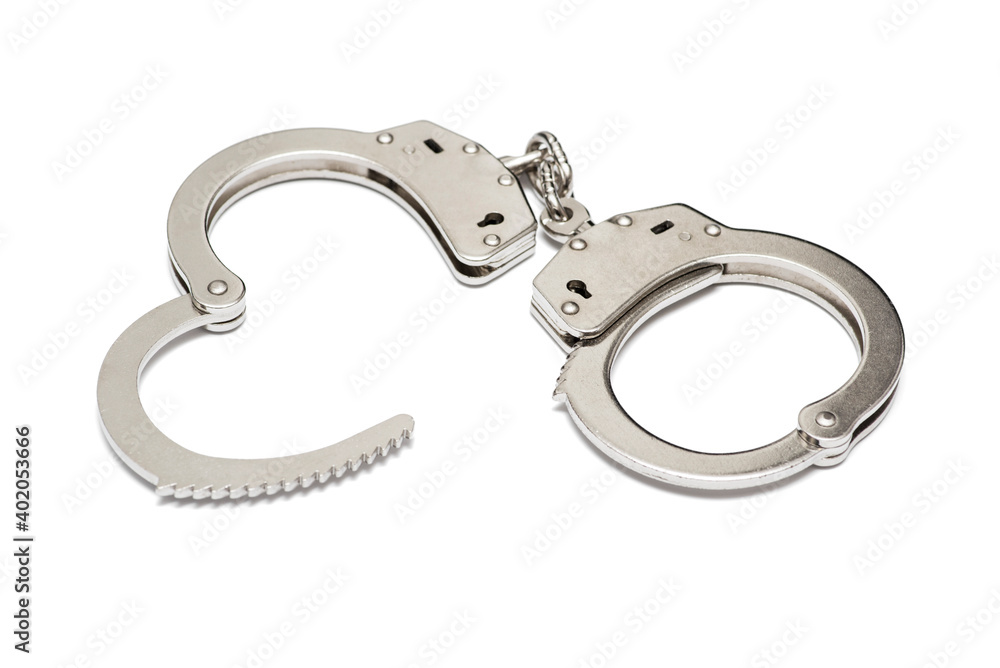 Pair of steel handcuffs isolated on white background. Silver metal handcuffs on white Pair of steel handcuffs isolated on white background. Silver metal handcuffs on white