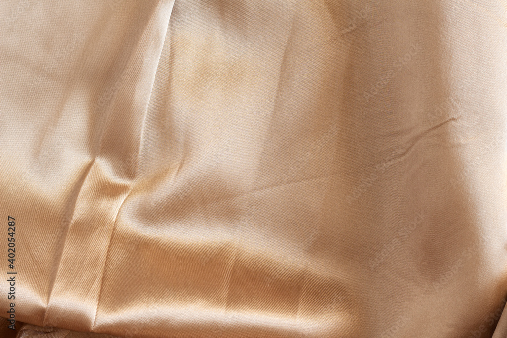 Texture of beige satin shiny fabric Texture of beige satin shiny fabric