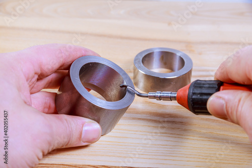 Deburring tool for metal, wood, aluminum, copper and plastic. The process of deburring metal. photo