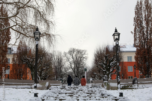 Принти на полотні Trio walking up wintery stairs between lamp posts
