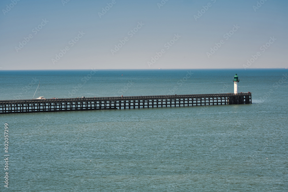 Pier with lighthouse, shoot from ferry at port of Calais, France