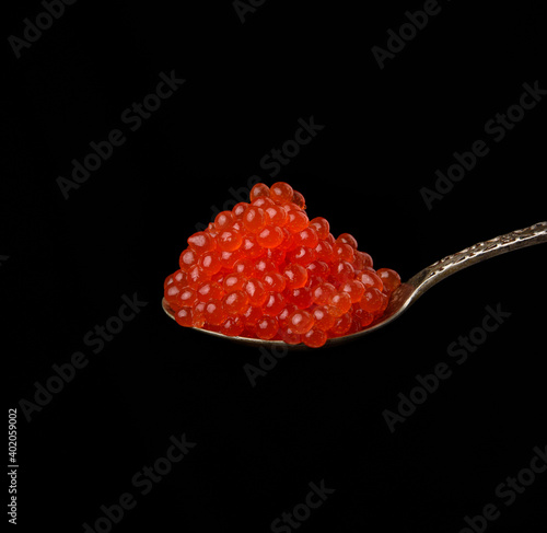 fresh grainy red chum salmon caviar in a metal spoon