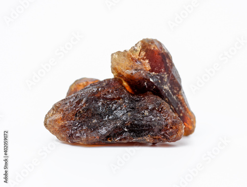 pile of brown cane sugar lump on white background