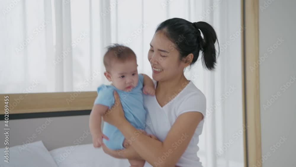 Family concept of 4k Resolution. Asian mom is holding a baby in the house. Family concept of 4k Resolution. Asian mom is holding a baby in the house.