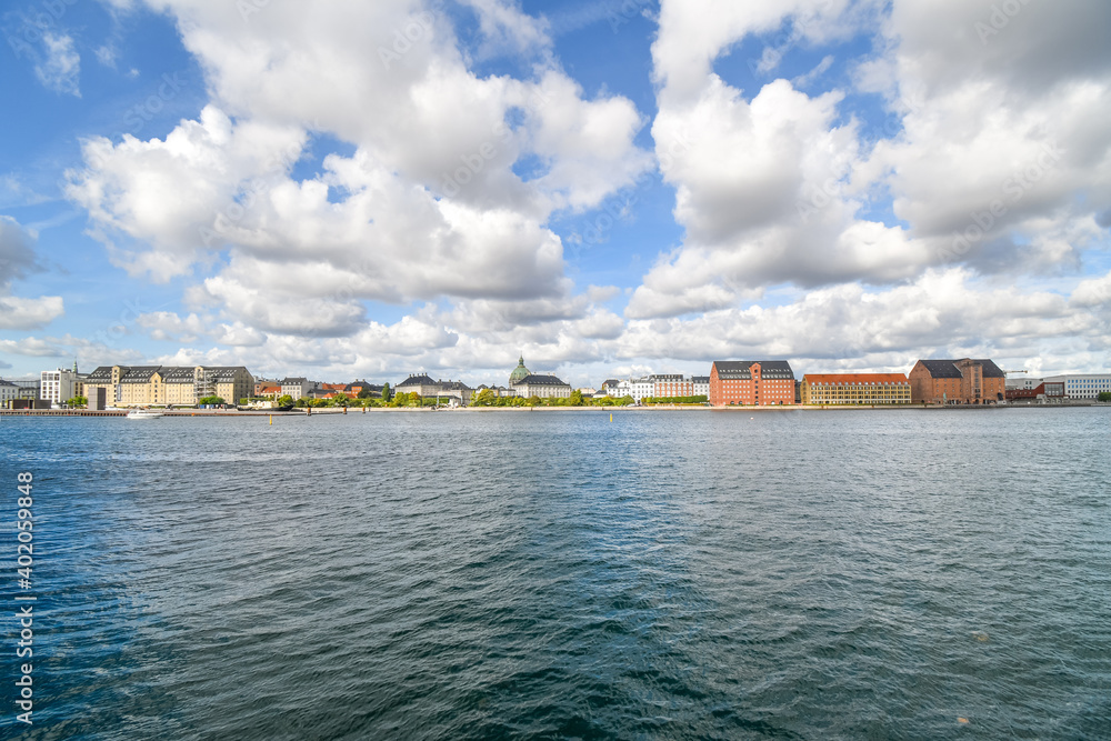 View across the water from Holmen Island of the Amalienborg castle and the Marble or Frederik's Church in Copenhagen Denmark.