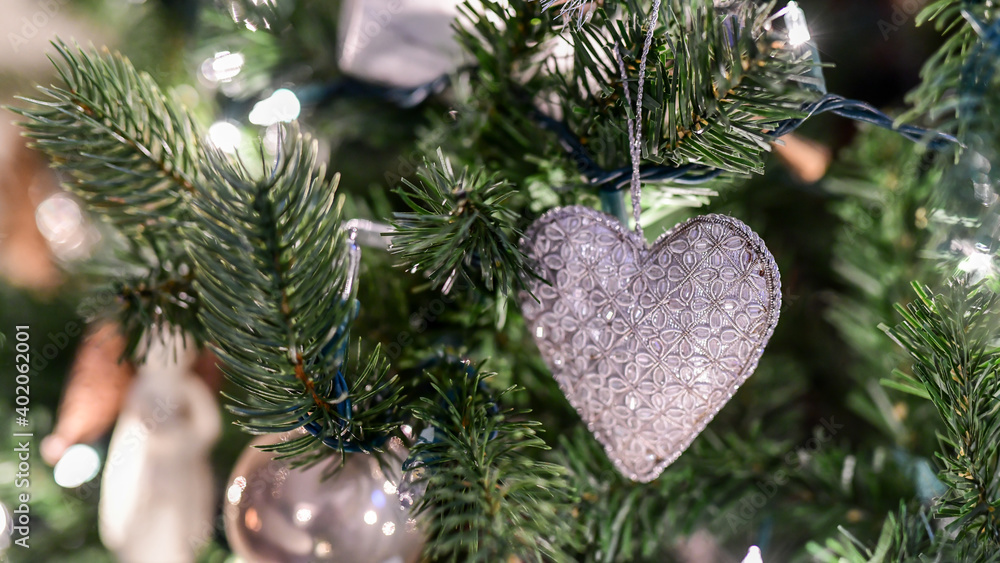 Fototapeta premium Christmas Holiday ornaments hanging from the tree