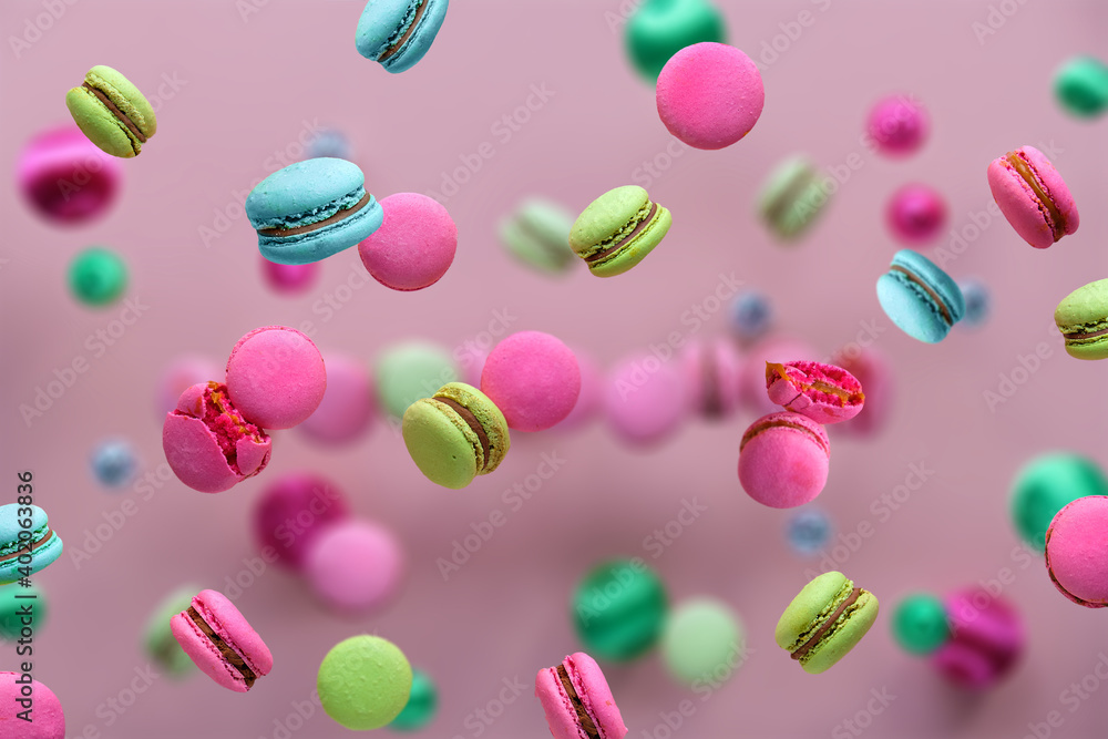 Levitation of macaroons, creative food concept. Bold vibrant pink, mint green, mint blue and magenta colors. Flying macaroons, disco balls and decorative metallic balls on pink background. Levitation of macaroons, creative food concept. Bold vibrant pink, mint green, mint blue and magenta colors. Flying macaroons, disco balls and decorative metallic balls on pink background.