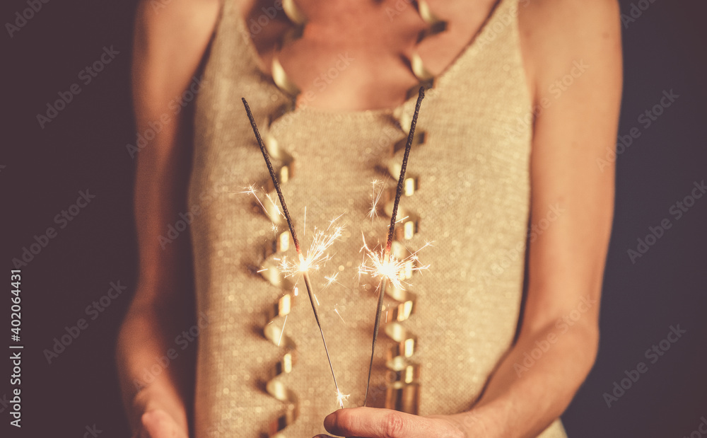 woman holding sparklers New Year's eve party