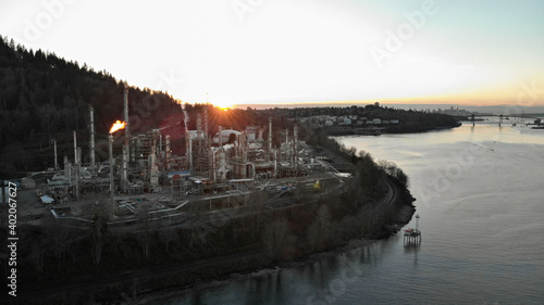 A aerial hyperlapse of an oil refinery in Burrard Inlet with a view of downtown Vancouver, Canada, in the background.
