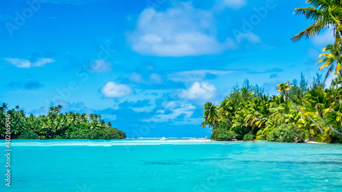 Pacific islands, the turquoise sea and the white clouds in the blue sky create a peaceful scene in Arutanga - One Foot Island  photo