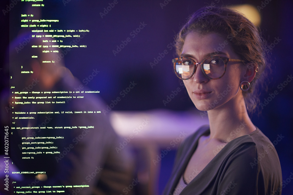 Portrait of professional young soft developer wearing eyeglasses working in evening looking at camera, medium close-up portrait Portrait of professional young soft developer wearing eyeglasses working in evening looking at camera, medium close-up portrait
