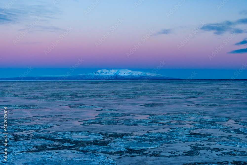 Fototapeta premium Mount Susitna just before dawn in winter, lit by the alpenglow (taken from Anchorage, Alaska)