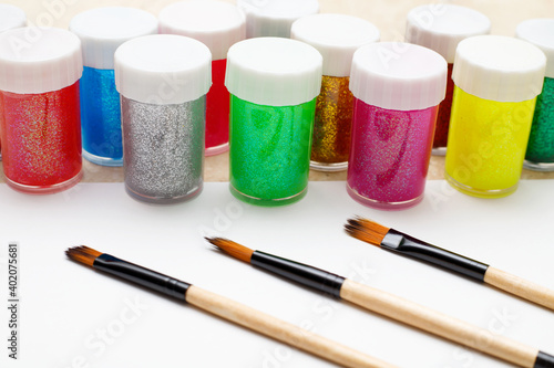 Paints and paintbrushes on the table. Crafts, arts and hobby concept.