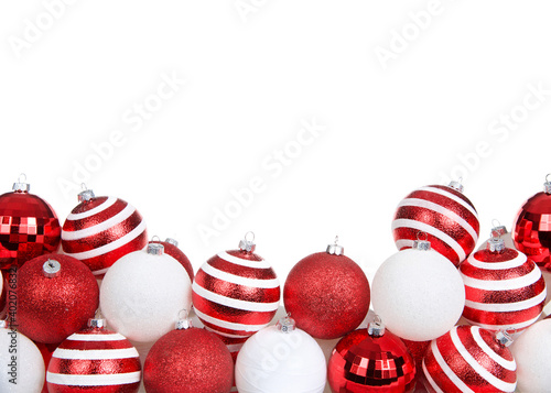 Photography red white and striped Christmas tree ornaments piled decoratively in a row isolated on white background