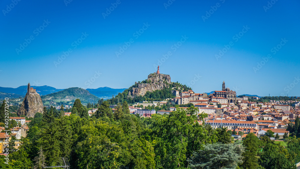 A panorama of the medieval city of Le Puy en Velay (Auvergne, France). You can see St Michel D'Aiguilhe rock, the statue of our lady of France and Notre Dame Cathedral