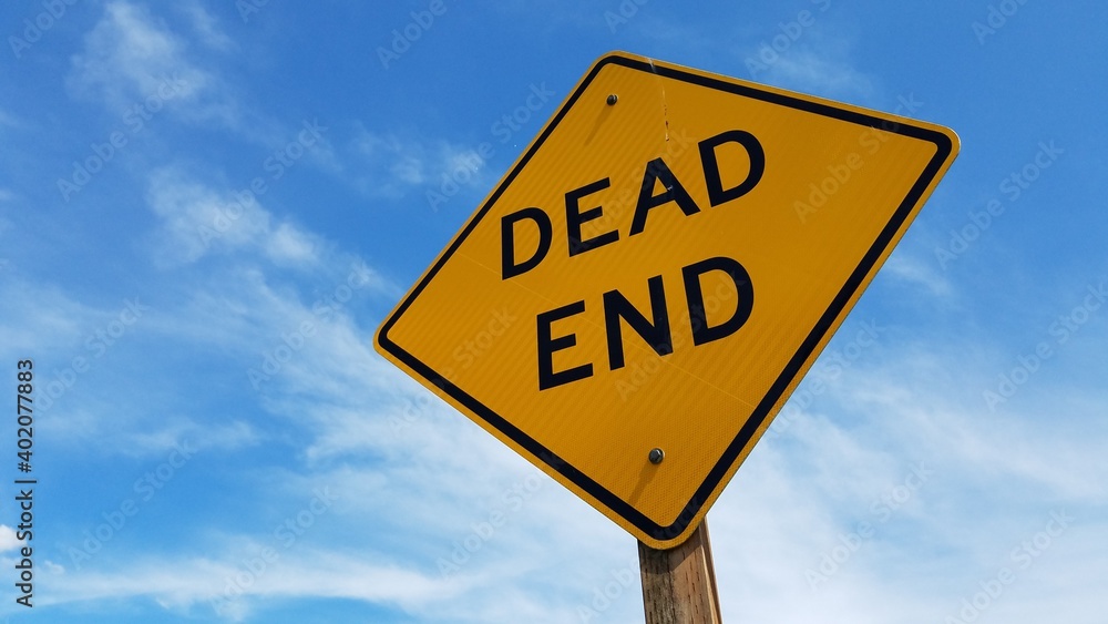 Dead End signage with clear blue sky background