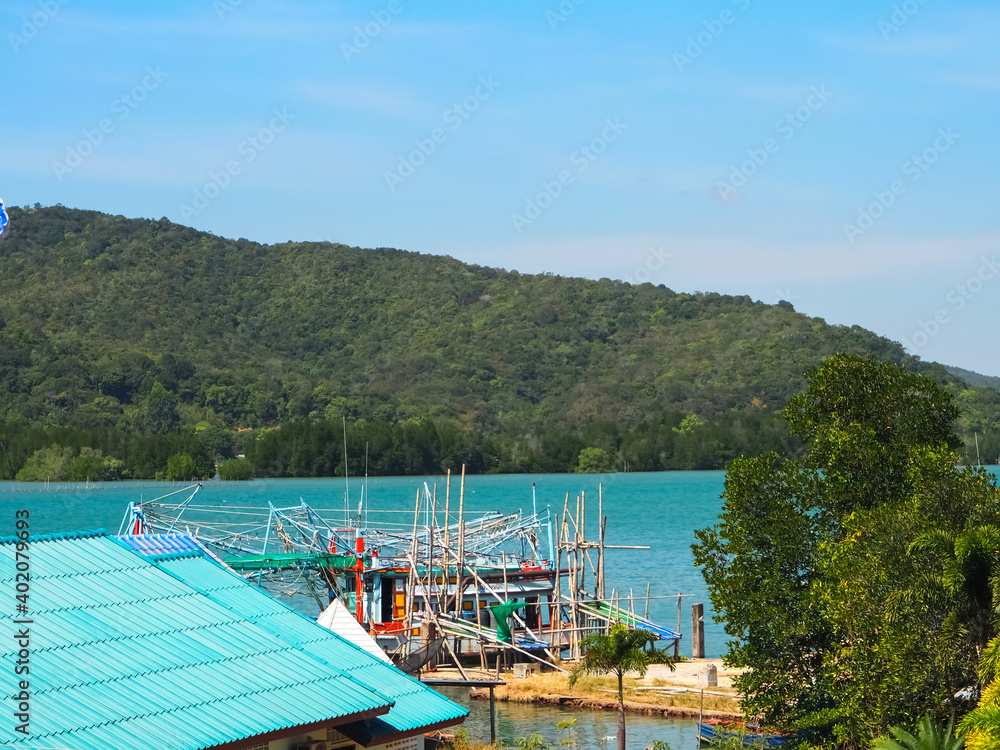 Fototapeta premium Fishing boats moor to fish by the sea and in the surrounding mountains