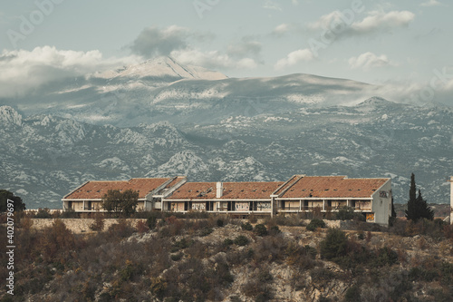 A landscape of abandoned hotel with Velebit mountain range background in Maslenica photo