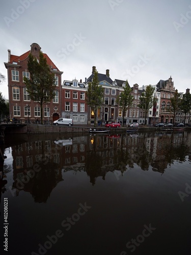 Typical Amsterdam style architecture exterior facade reflection of houses buildings in Amstel canal Holland Netherlands photo