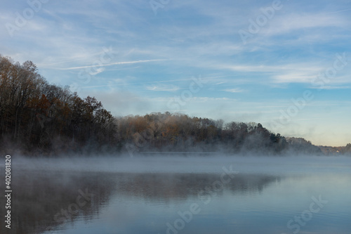 Fototapeta Naklejka Na Ścianę i Meble -  Sunrise over a foggy lake in winter on Lake Lanier in Georgia, USA