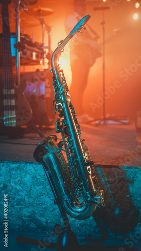 Canvas Print A vertical shot of a saxophone on a stand behind the stage during a concert