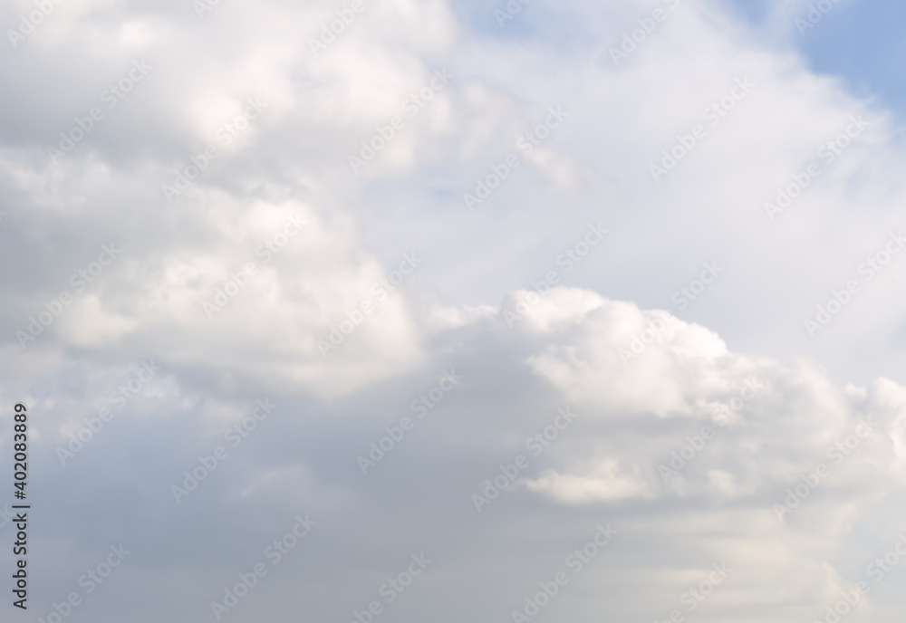 The clouds in the sky. White fluffy clouds on a light background