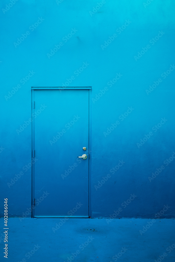 Gradient over the wall and the door exterior. The trendy blue color on the concrete. Gradient over the wall and the door exterior. The trendy blue color on the concrete.