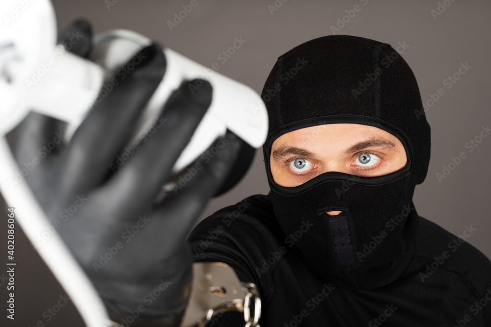 Thief turning off surveillance camera Thief turning off surveillance camera