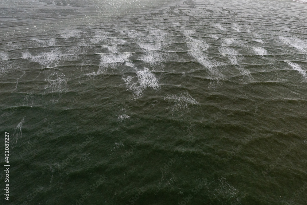 Hudson Bay, the Arctic Ocean from aerial, drone, heli, plane view above the crashing waves on the shores of Canada, Manitoba & Nunavut. Churchill, polar bear season. 