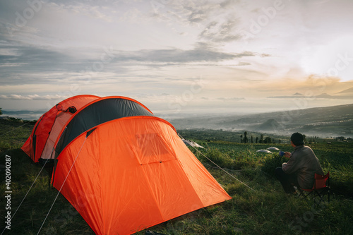 Asian man camping with sunrise view in mountain  Posong Temanggung  Indonesia