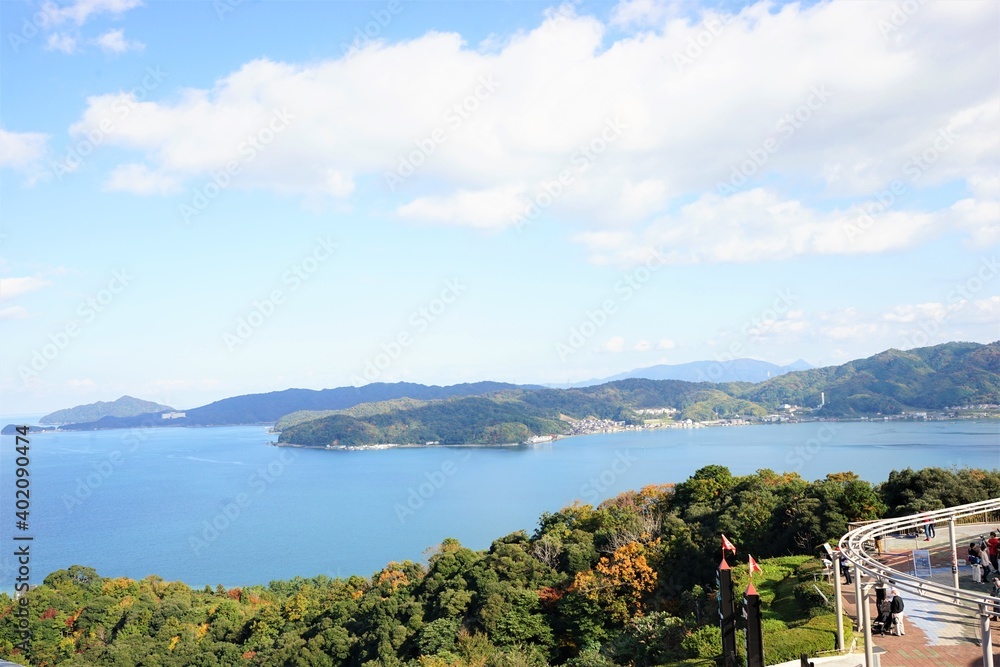 Aerial view of Amanohashidate with red and yellow foliage , Kyoto, Kansai Region, Japan - 天橋立と紅葉した山