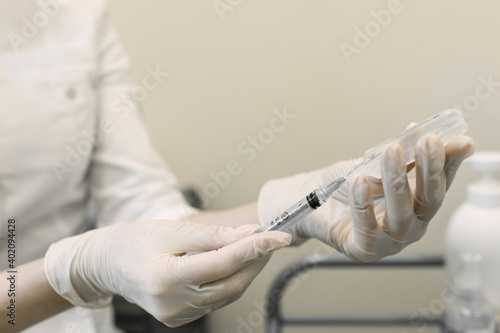 the doctor draws the medicine into the syringe