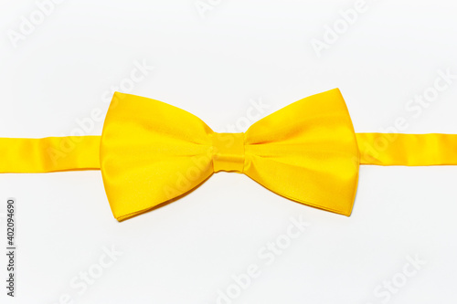 Fotografia Close-up of yellow bow tie on white background.