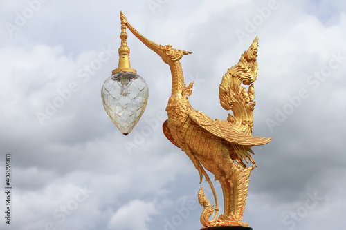 Golden hongsa sculpture in Thailand on cloud background golden swan statue