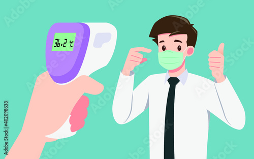 A hand holding digital infrared thermometer checking body temperatures to prove that a businessman who wear mask were safe in the public. Social distancing to safe people from coronavirus, covid-19.