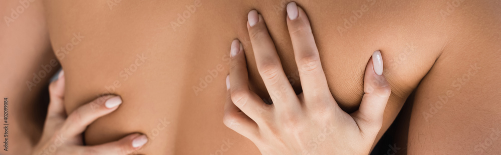 Cropped view of woman touching back of muscular man, banner Cropped view of woman touching back of muscular man, banner