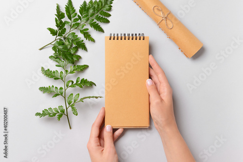 Female hands with blank not...