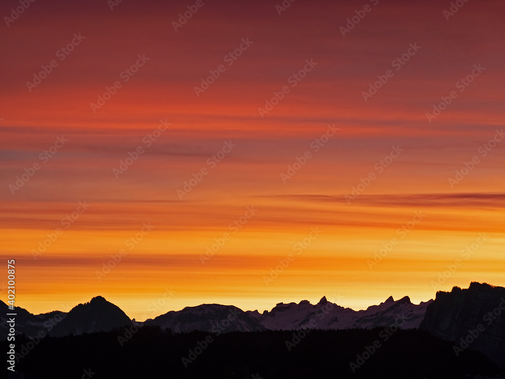 Burning sky over the Swiss Alps before sunrise Burning sky over the Swiss Alps before sunrise