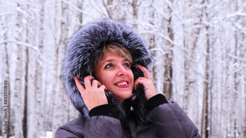Winter portrait of a young beautiful brunette woman in a winter jacket with fur. Snow winter beauty concept Winter portrait of a young beautiful brunette woman in a winter jacket with fur. Snow winter beauty concept