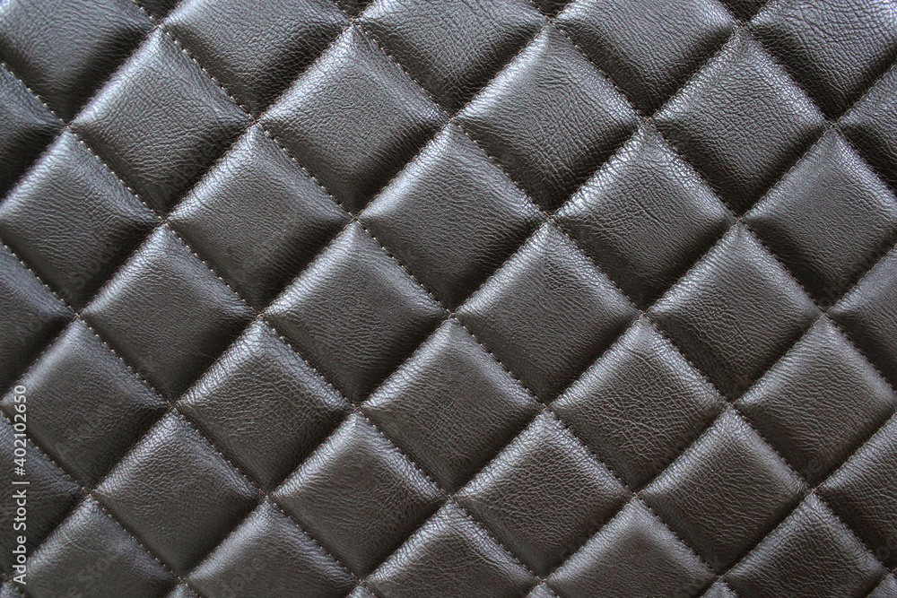 Fototapeta premium Stitched leather. Background of diamond-stitched leather. Close-up photos, selective focus.