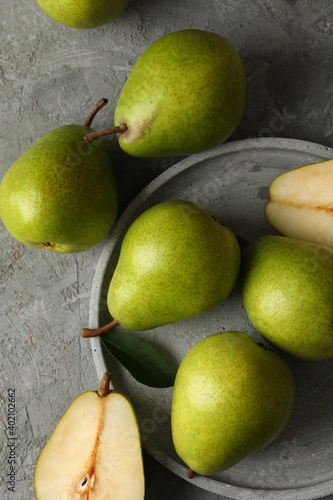 Tray with green pears on gray background