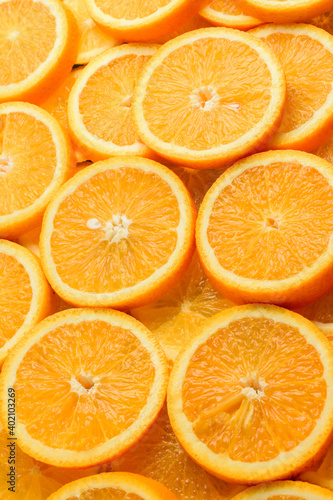 Texture of sliced orange  fresh and healthy fruit  which is rich in juice and vitamin c. Orange background.