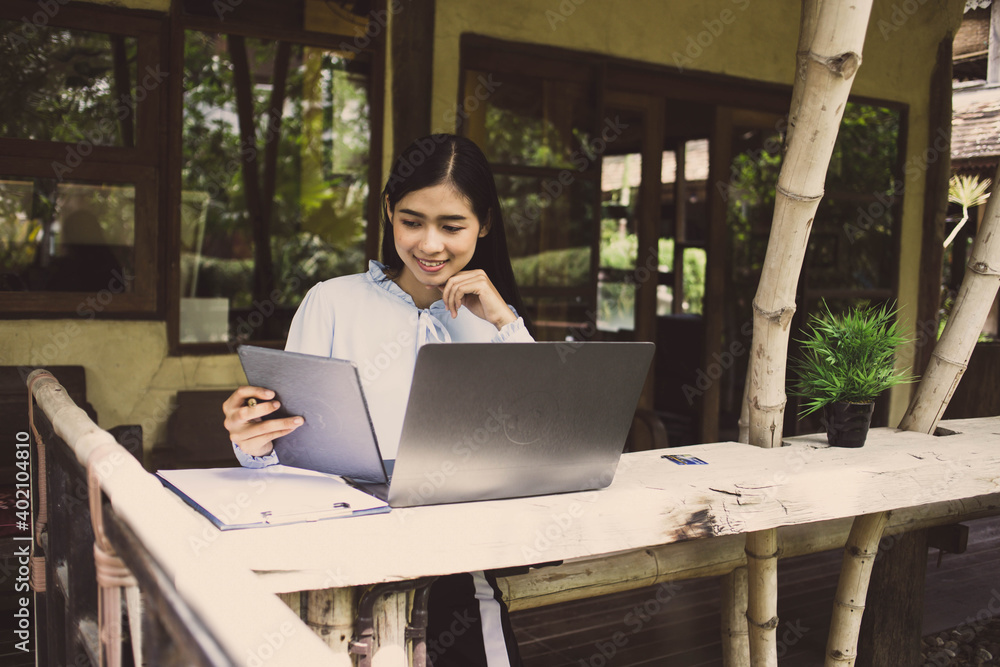 businesswoman hands searching for data on Notebook with tax online  work at home.concept