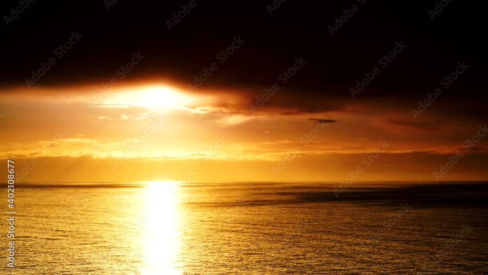 Seascape. Dramatic sunset over sea with dark clouds moving over water surface, time lapse. Nature evening landscape. Seascape. Dramatic sunset over sea with dark clouds moving over water surface, time lapse. Nature evening landscape.