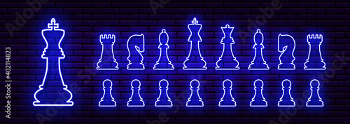 A set of neon chess pieces, each element isolated separately. Volume version with a shadow. Against a brick wall. For design, signage, billboards. In shades of blue. Sham and checkmate. Realistic lamp