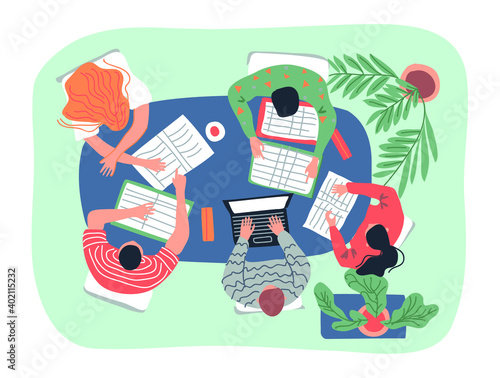 image of people sitting at a desk at work discussing a project